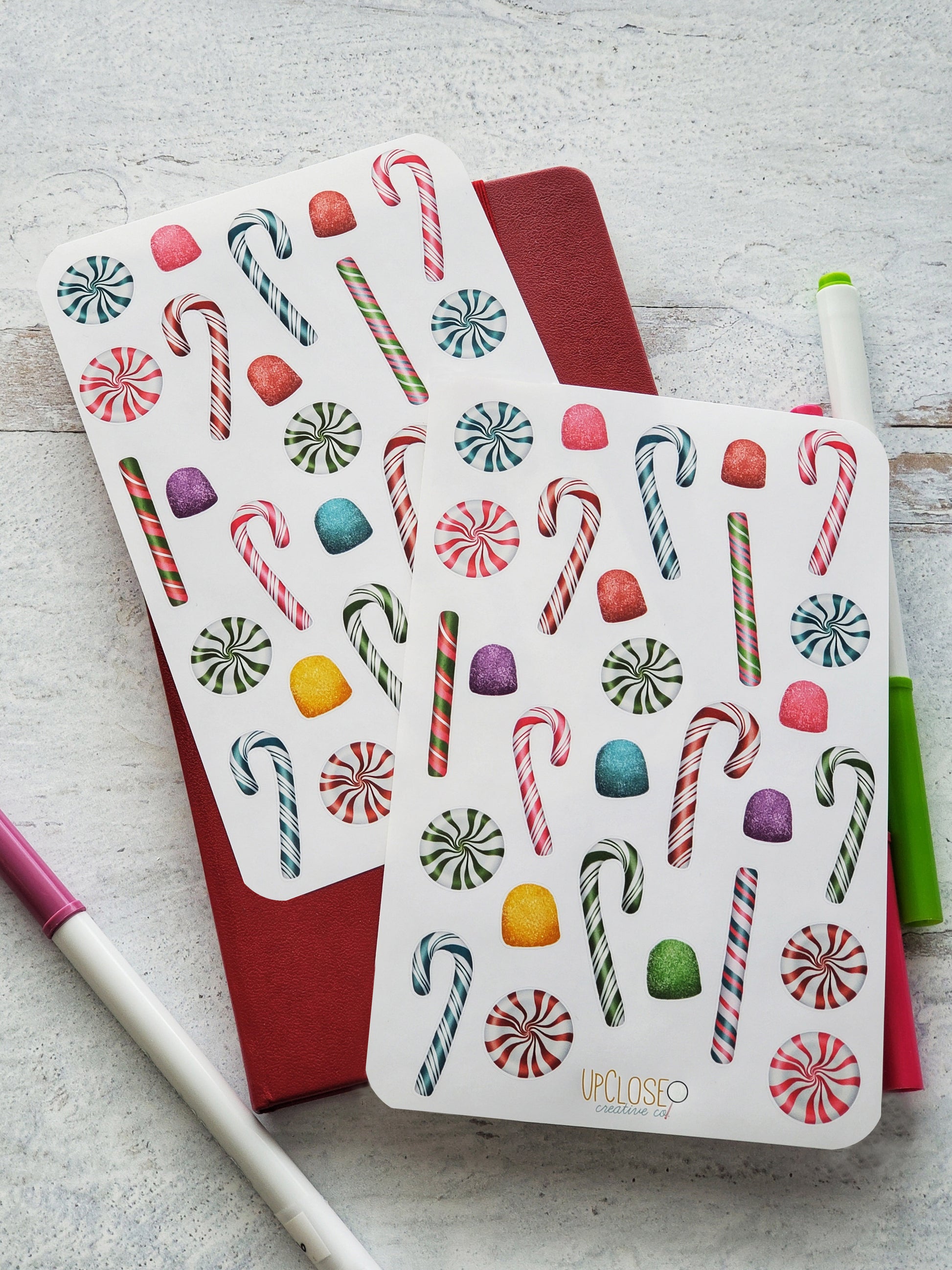 Set of 2 sticker sheets featuring colorful illustrated peppermints, candy canes and gumdrops. 