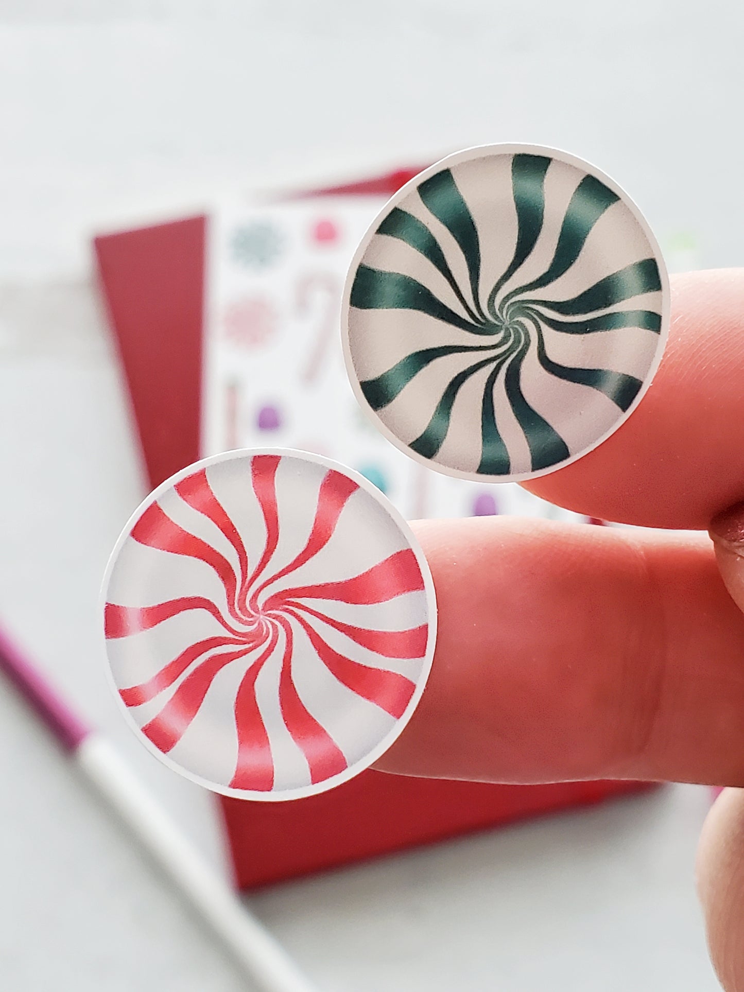 Close up of a pink peppermint sticker and a teal peppermint sticker.